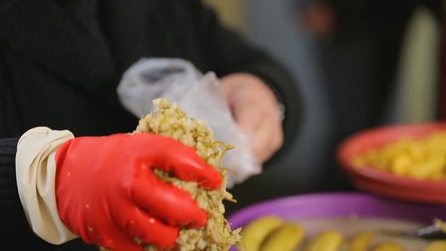 Saleswoman serving customer, packing jonjoli in plastic bag, quality control