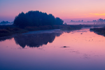 Early morning, dawn over the lake. Misty morning, rural landscape, wilderness, mystical feeling