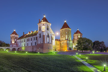 Fototapeta na wymiar Travel Places and Torist Destinations. Picture of Renowned Mir Castle as Former Bastion and Fortress of The Great Lithuanian Kingdom, Present Belarus.Shot During Blue Hour