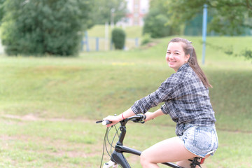 Fototapeta na wymiar Girl teenager on a bicycle