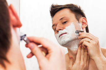 Shaving man in the mirror