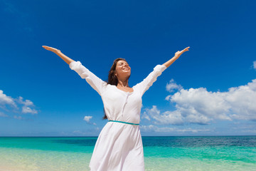 Woman in a white dress on beach