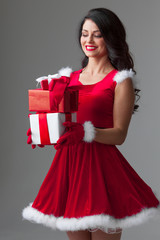 Fototapeta premium Woman in santa dress with gift