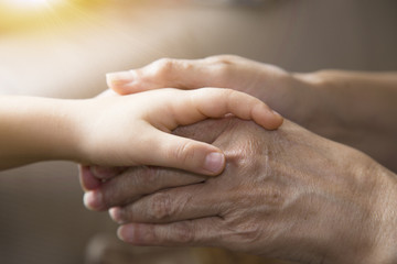The mother is holding the hand of the baby. Mother's and baby's hands. Family concept 