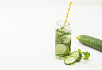 Drink of chopped cucumber and mint on white background