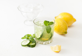 Drink of chopped cucumber, mint and lemon on white background