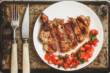 fried meat with tomato salsa salad