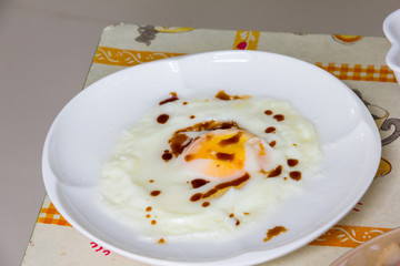 fired egg with sause on white dish