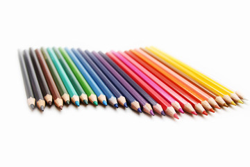 Colored Pencils as background / is an art medium constructed of a narrow, pigmented core encased in a wooden cylindrical case
