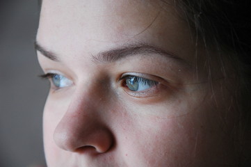 Fototapeta premium Part of the girl's face is close-up - eyes and nose.