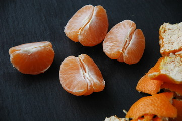 A few tangerines close-up on a black background.