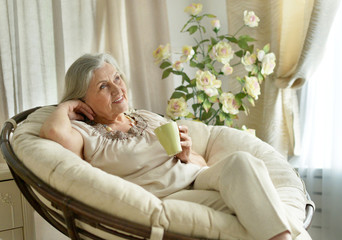 Senior woman resting at home with tea cup