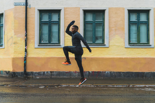 Sportive man running on street
