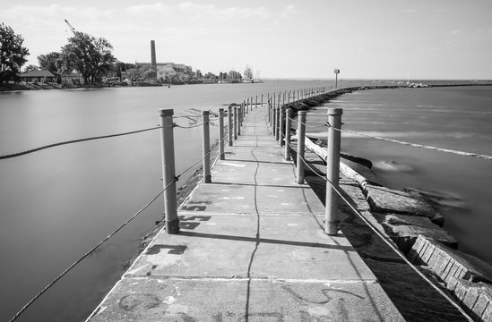 Exterior daytime black and white long exposure stock photo of concrete trail on Bird Island Pier in Niagara River adjacent to Lake Erie in Buffalo New York