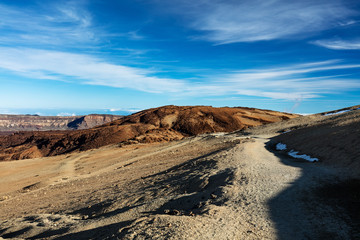 Teide National Park, Tenerife, Canary Islands - Gravel footpath of the Montana Blanca volcanic ascent trail. This scenic hiking path leads up to the 3718 m Teide Peak, the highest peak in Spain.