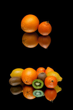 orange and other fruits on a black background