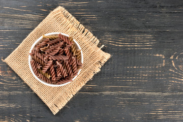 Dark fusilli pasta in bowl