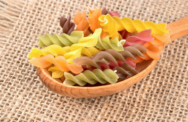Colorful fusilli pasta in spoon