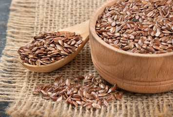 Flax seeds in spoon and bowl