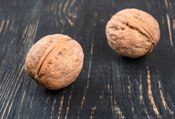 Two walnuts on table