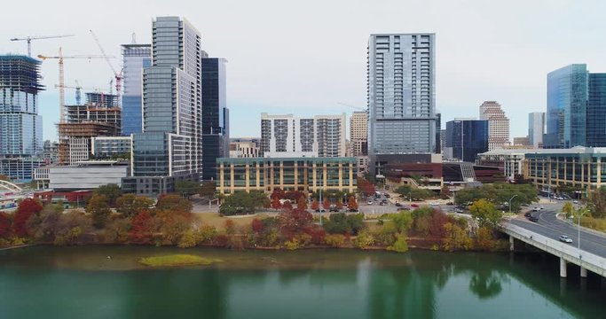 A low profile aerial view of the Austin, Texas skyline with the Colorado River in the foreground. Late Autumn overcast day.  	