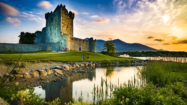 Landscape time lapse of a sunset with a lake and old castle with orange clouds in 4K UHD HDR 422 10 bit ProRes