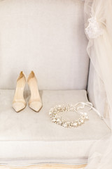 Wedding wreath, shoes and veil on the sofa