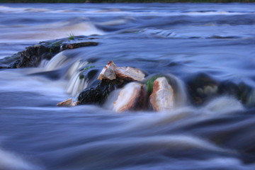water flow on long exposure. small waterfall on mountain river stream. river rapids close up.