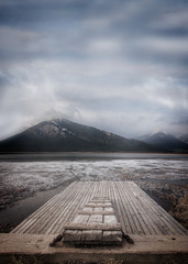 Rocky Mountain lake in winter with dock and ice