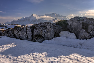 Beautiful scenic snowy winter mountain peak blue sky landscape. Mountain peak Oshten in Lagonaki, Caucasus mountains, Russia