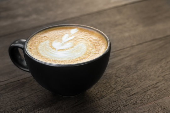 Latte art coffee on table.
