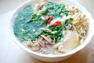 Bun Thang - traditional vietnamese rice noodles with shredded chicken, ham and eggs which is garnished by chopped cilantro, spring onion and chili slices.