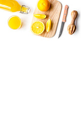 Freshly squeezed orange juice. Juicer and slices of oranges on white background top view copyspace