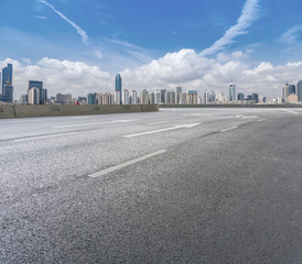 Road pavement and city skyline