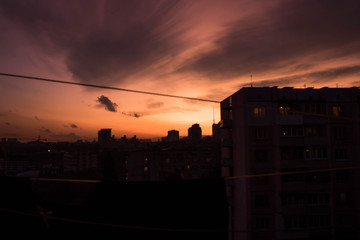 City roofs on sunset cloudy sky