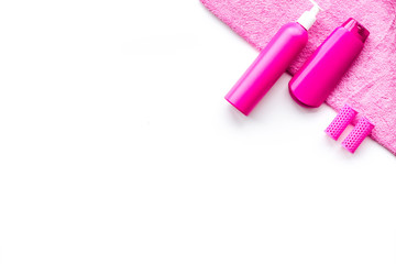Women hair care set. Shampoo, spray, curlers on white background top view copyspace