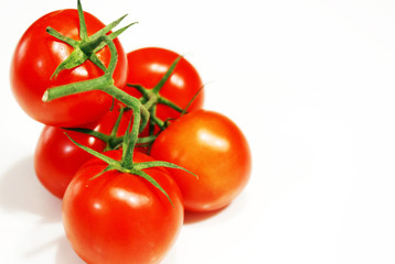 still life of fresh red tomatoes with green stalk isolated on white background