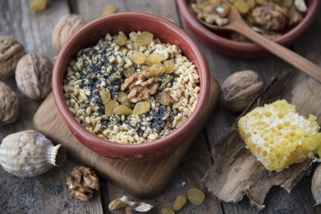 traditional Christmas dish of Slavs - kutya on the wooden background with poppy seeds and welnuts 