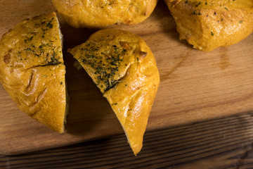 Fresh bread ciabatta on cutting board on wooden table