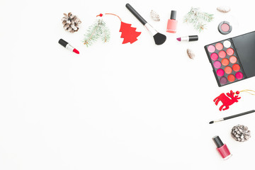 Fototapeta na wymiar Fashion desk with cosmetics, accessories and New Year decoration, confetti on white background. Flat lay, top view.