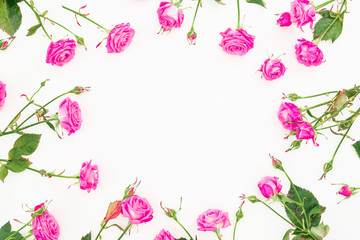Floral round frame with pink roses, branches and leaves on white background. Flat lay, Top view. Valentines day composition