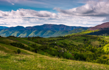 Fototapeta na wymiar beautiful mountainous countryside in springtime. village outskirts with rural fields on rolling hills.