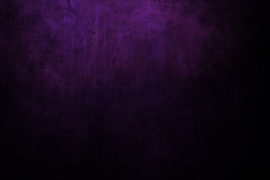 dark purple grungy background with spotlight background