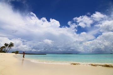 panorama of a tropical beach and a girl in the distance