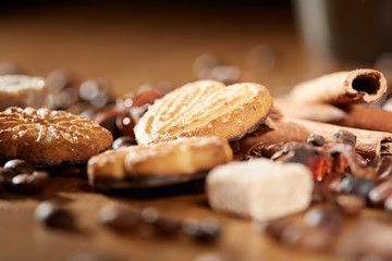 Aroma coffee chocolate cookies and spices on the wooden table. Dark wooden background. Top view. Close. Closeup.