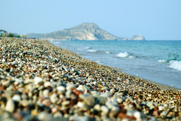 Pebble beach and blue sky on background