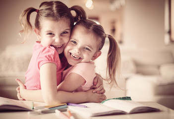 Fototapeta premium Creative cute girls hugging and looking at the camera.