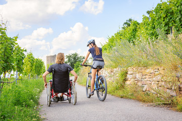 Young Couple In Wheelchair Enjoying Time Outdoors