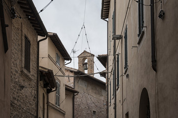 Fototapeta na wymiar Spectacular traditional italian medieval alley in the historic center of beautiful little town of Spello (Perugia), in Umbria region - central Italy