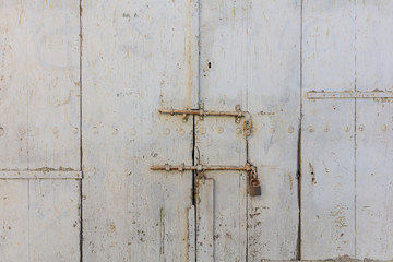 Wooden light grey, old and peeled background. Close up view with details. Space for text.